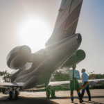 Pilots inspect a private jet before takeoff.