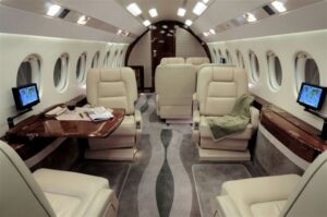 Large-cabin heavy jet setup for work and dining inside a Falcon 2000EX