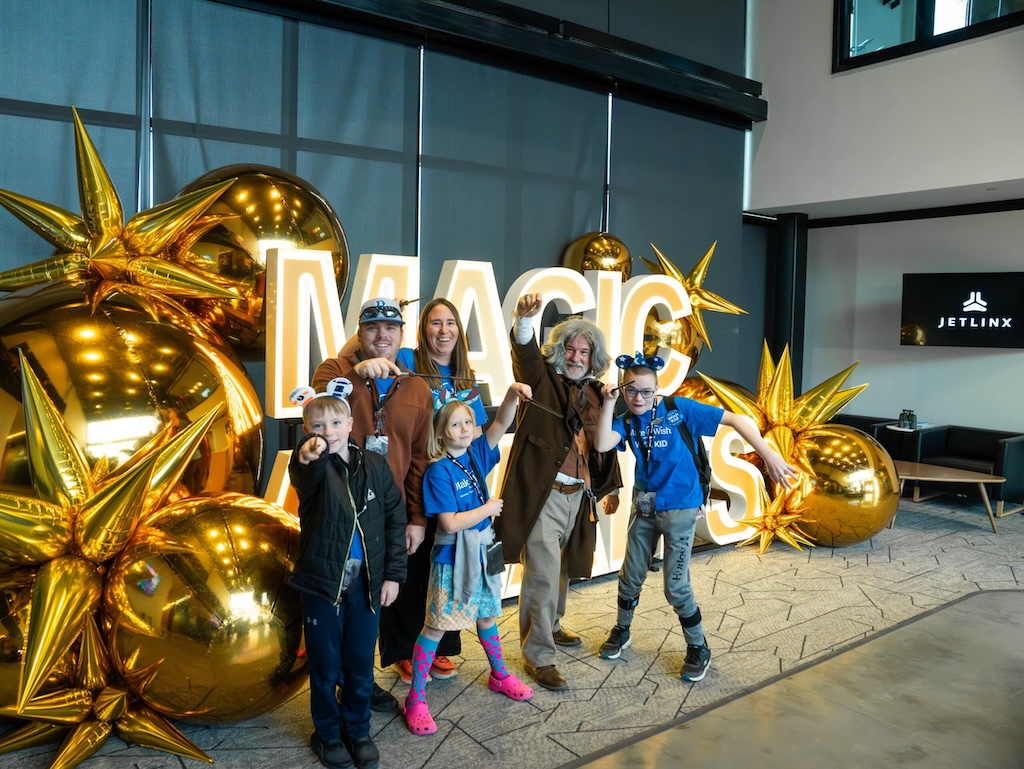 Make-A-Wish recipient Keyton receiving a custom wand at Jet Linx Omaha airport sendoff.