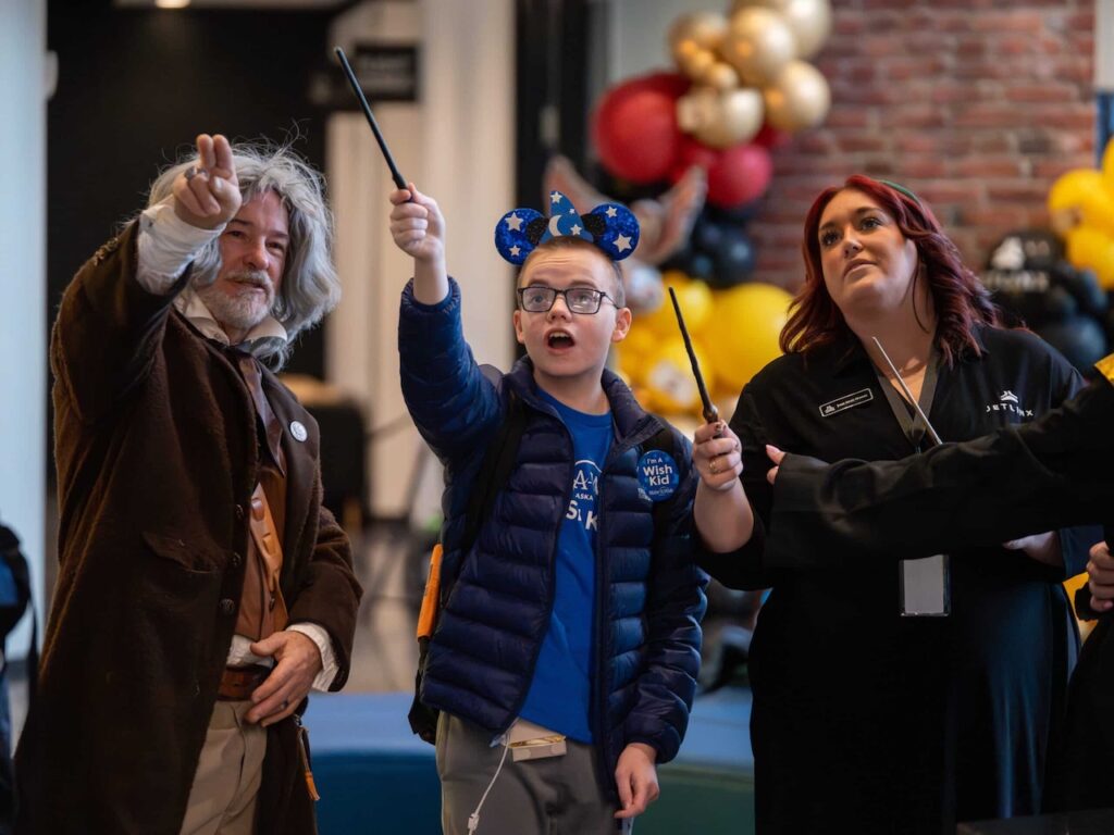 Make-A-Wish recipient Keyton receiving a custom wand at Jet Linx Omaha airport sendoff.