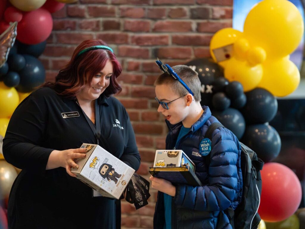 Make-A-Wish recipient Keyton receiving a custom wand at Jet Linx Omaha airport sendoff.