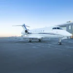 Sleek private jet illustrating the premium travel experience behind jet card vs charter comparisons.