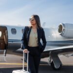 Confident businesswoman standing by a private jet, ready for luxurious travel.